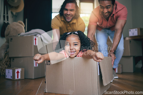 Image of Family home, girl and box with father, push and gay parents with games, portrait and excited on floor with moving. LGBTQ men, female kid and cardboard package for car, airplane and speed in new house