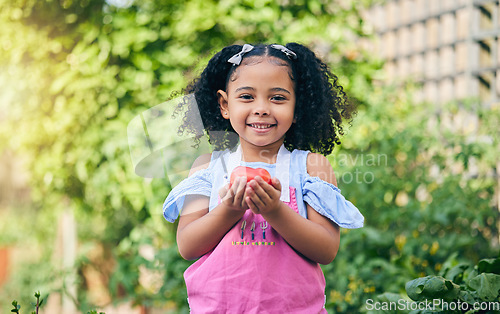 Image of Girl child, apple and portrait in garden for growth, sustainability and happy for harvest, agriculture or food. Young female child, smile and fruit for health, diet or nutrition in summer sunshine