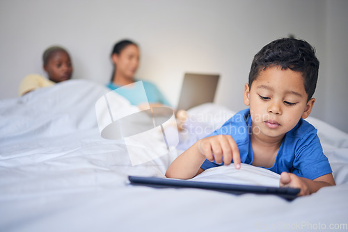 Image of Children, tablet and education with a family in bed in the morning to relax together at home. Kids, technology and child development with a little boy in the bedroom to play a fun online game