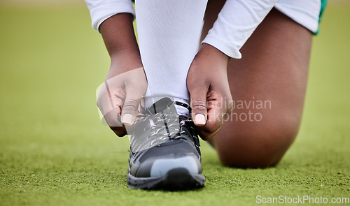 Image of Lace shoes, sports person and field for training, performance or workout on grass turf. Closeup hands of athlete tie sneakers, footwear and feet to start exercise for game, fitness or contest on lawn