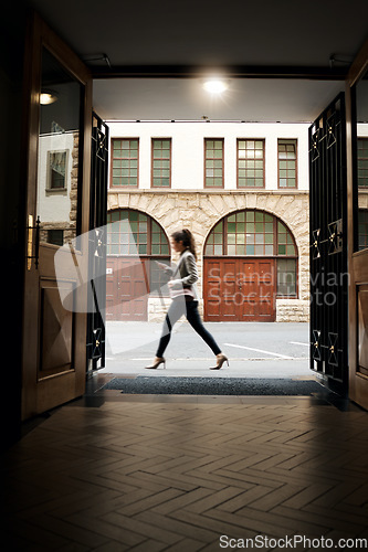 Image of Phone, door and a woman tourist walking in the city on an overseas trip to search for directions to a location. Building, architecture and travel with a person in an urban town for a vacation abroad