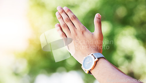 Image of Hand, time and watch with a person outdoor in nature on a green background for freedom, meditation or zen. Yoga, fitness and wellness with an adult alone in the park, garden or backyard closeup