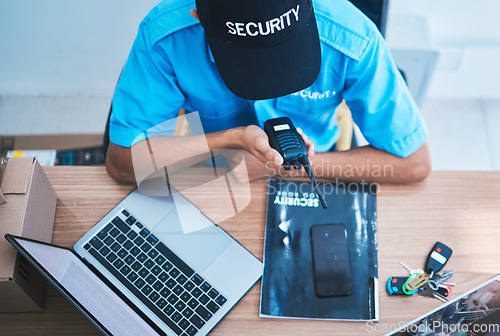 Image of Security man, radio and talk in office with top view for safety, surveillance and communication at job. Guard, walkie talkie and contact for information, protection service and laptop in control room