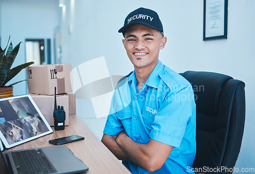 Image of Security guard man, portrait and smile to monitor with laptop, tablet and arms crossed in control room. Young safety officer, surveillance expert and happy for job, protection service and computer