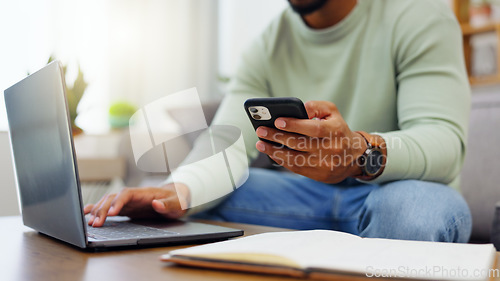 Image of Phone, laptop and man hands typing while doing research for a freelance project in his living room. Technology, keyboard and male freelancer working online with a computer and cellphone at his home.
