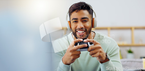 Image of Gaming, winner and esports with a man in the living room of his home, playing a video game for fun. Winning, celebration and next level with a gamer using a joystick controller to play console games