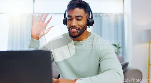 Image of Video call, black man and work from home, virtual communication or remote client tech support in call center career. Hello, wave of indian person, agent or consultant in living room on laptop talking