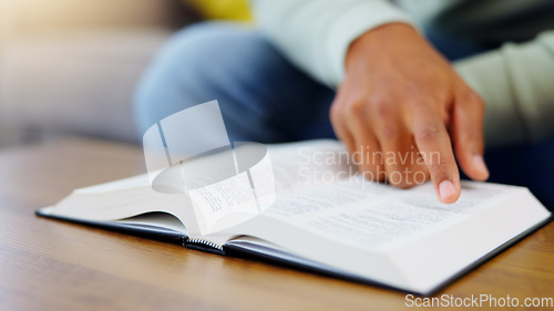 Image of Prayer, reading and bible with man in living room for worship, spiritual and Christian faith. Hope, God and belief with person praying with holy book at home for religion, thinking and gratitude