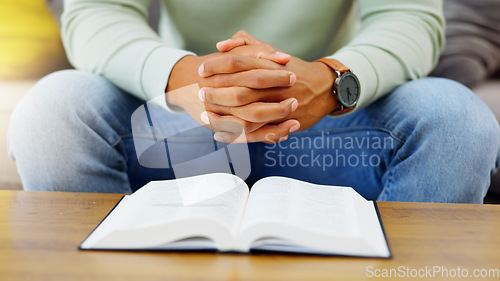 Image of Prayer, peace and bible with hands of person in living room for worship, spiritual and Christian. Hope, God and belief with closeup of man with holy book at home for religion, praying and gratitude
