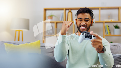 Image of Gaming, winner success and esports with a man in the living room of his home, playing a video game for fun. Winning, celebration and next level with a gamer using a joystick controller to play consol