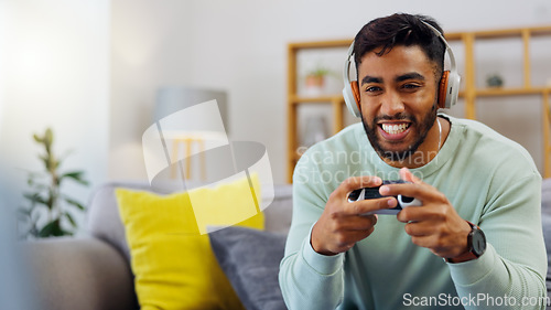 Image of Gaming, winner and esports with a man in the living room of his home, playing a video game for fun. Winning, celebration and next level with a gamer using a joystick controller to play console games