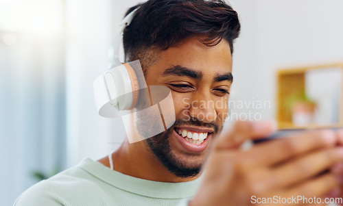 Image of Laugh, happy and mobile text of a black man typing on social media communication app. Laughing, internet scroll and web meme of a man online on a mobile phone texting and reading a funny joke