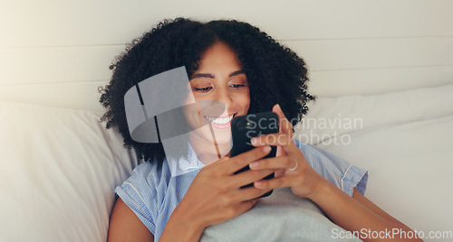 Image of Phone, happy woman and bed of a young female texting on a social media app in the morning. Wifi, web networking and happiness of a young person with a smile in a house writing a text in a chat