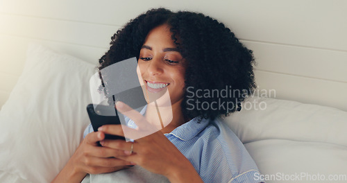 Image of Phone, happy woman and bed of a young female texting on a social media app in the morning. Wifi, web networking and happiness of a young person with a smile in a house writing a text in a chat