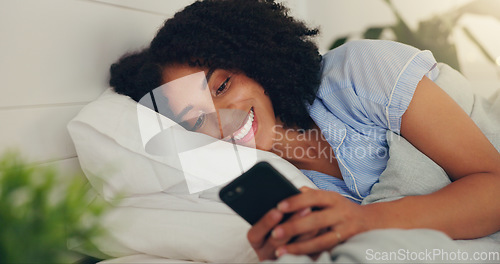 Image of Phone text, happy woman and bed of a young female texting on a social media app in the morning. Wifi, web networking and happiness of a young person with a smile in a house reading a message