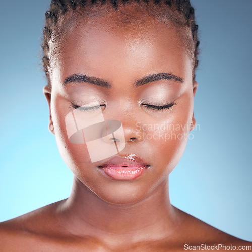 Image of Beauty, studio face and black woman relax with self care wellness, natural skincare or and facial makeup. Makeup cosmetics, spa salon and African person with eyes closed on blue gradient background