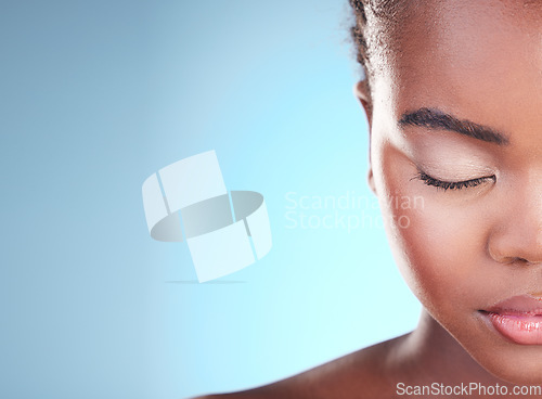Image of Beauty, half face mockup and black woman relax with self care wellness, eyeliner cosmetics or eyebrow treatment. Advertising makeup, studio space or African person with eyes closed on blue background