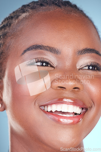 Image of Face of black woman for skincare, beauty and smile on blue background for wellness, health and spa. Salon aesthetic, dermatology and closeup of happy person in studio with cosmetics, makeup and glow