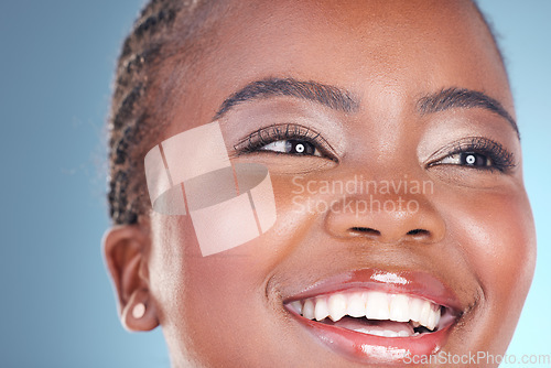 Image of Face of happy black woman for skincare, beauty and facial on blue background for wellness, health and spa. Salon aesthetic, dermatology and closeup of person in studio with cosmetics, makeup and glow