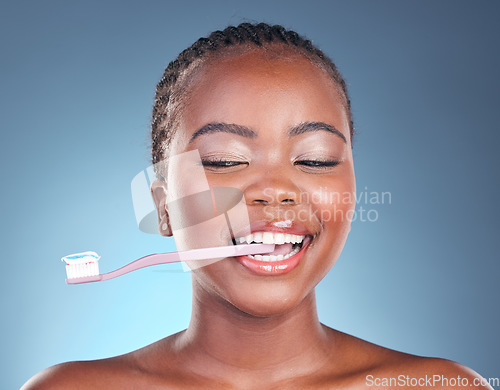 Image of Happy black woman, toothbrush and teeth in dental cleaning or care against a studio background. Face of African female person smile in morning routine tooth whitening, oral or mouth and gum hygiene
