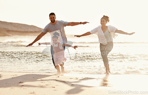 Image of Family, running in ocean and freedom on beach with sunshine, fun together with games and bonding on vacation. Travel, adventure and playful, parents and child with happy people in nature and energy