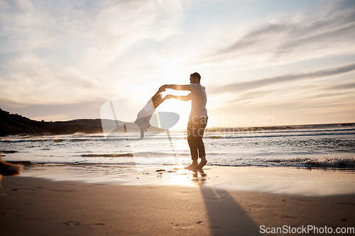 Image of Swing, love and father with girl child at a beach holding hands in nature for play, freedom or bond at sunset. Ocean, travel and parent with kid at sea for spinning fun, games or celebration in Bali