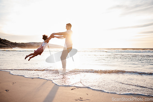 Image of Beach, swing and father with girl child holding hands in nature for play, freedom or bond at sunset. Ocean, travel and parent with kid at sea for spinning fun, games and celebration adventure in Bali