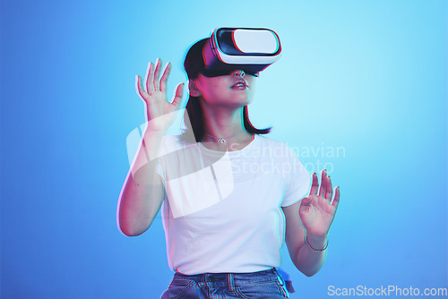 Image of Woman, VR and glasses for futuristic metaverse, 3d games and gen z education or digital e learning. Young person or student in virtual reality, high tech with vision, neon and blue,studio background