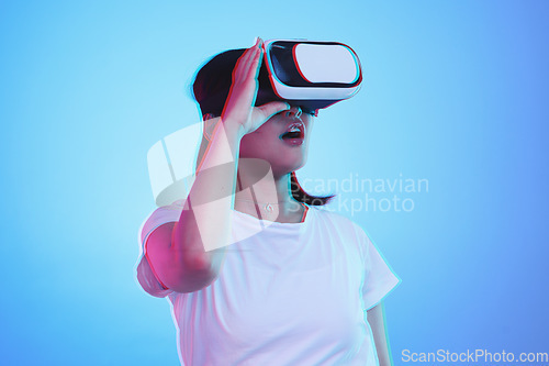 Image of Woman, VR and vision with wow for futuristic experience, 3d games and gen z education or digital e learning. Student with surprise for virtual reality, high tech and glasses on blue studio background