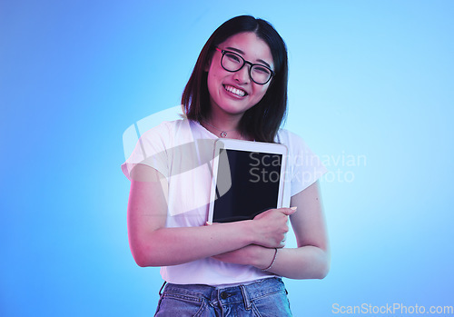 Image of Young woman, student and tablet mockup for online education, e learning or study on blue, studio background. Asian person with digital technology, marketing space and university information on screen