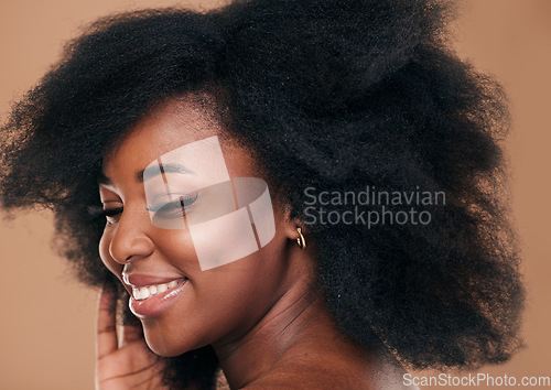 Image of Beauty, face and hair with a model black woman in studio on a brown background for natural cosmetics. Smile, makeup and haircare with a happy young afro female person indoor for shampoo treatment