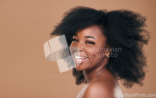 Image of Portrait, hair care and black woman with beauty, cosmetics and shine on brown studio background. Mockup space, person or African model with texture, afro or makeup with aesthetic, natural or wellness