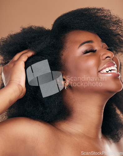 Image of Happy, black woman or hair care for afro, natural beauty or cosmetics on a brown studio background. Growth, hairstyle or African model with wellness, aesthetic or texture with salon treatment or glow