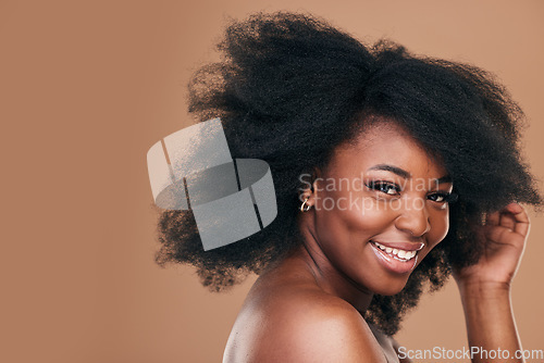 Image of Portrait, hair care and black woman with smile, beauty and wellness on a brown studio background. Mockup space, person and model with texture, afro and natural with aesthetic, makeup and cosmetics