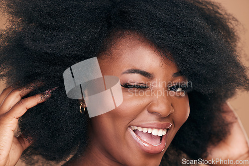 Image of Portrait, hair and wink with a natural black woman in studio on a brown background for organic cosmetics. Beauty, face and haircare with a happy young afro female person indoor for shampoo treatment