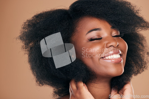 Image of Natural beauty, black woman and care for afro hair, smile and volume on a brown studio background. Aesthetic, hairstyle and African model with cosmetics after salon treatment, wellness and texture