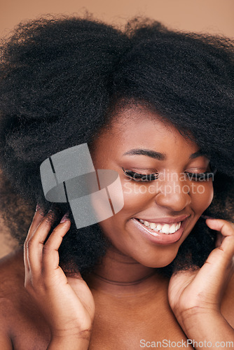 Image of Smile, black woman and natural hair care for afro, beauty and wellness on a brown studio background. Growth, hairstyle or African model with cosmetics, aesthetic or shine with salon treatment or glow