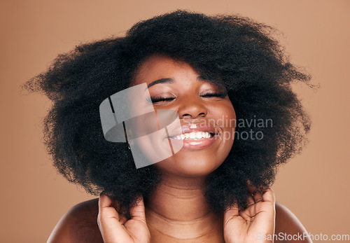 Image of Beauty, black woman and hair care for afro, natural and smile on a brown studio background. Growth, hairstyle or African model with cosmetics after salon treatment, makeup and wellness with luxury