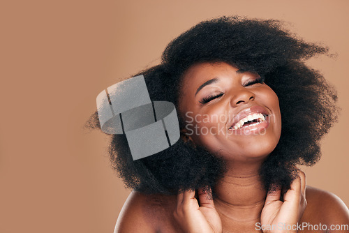 Image of Smile, black woman and hair care for afro, natural and beauty on a brown studio background. Growth, hairstyle and African model with cosmetics, mockup space or volume with salon treatment pr wellness