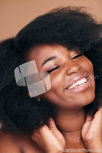 Image of Smile, black woman and hair care for afro, beauty and cosmetics on a brown studio background. Growth, hairstyle or African model with makeup after natural treatment, texture or shine with wellness