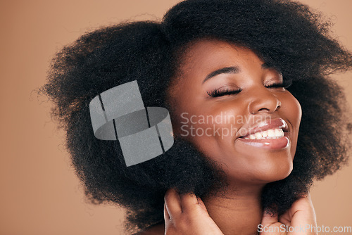 Image of Shine, black woman and hair care with a smile, natural beauty and wellness on a brown studio background. Growth, hairstyle and African model with cosmetics after salon treatment, luxury and aesthetic