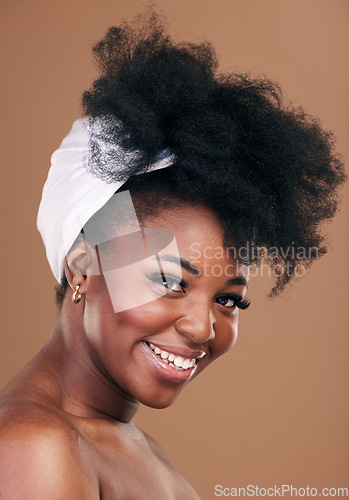 Image of Portrait, hair and smile for beauty with a black woman in studio on a brown background for natural cosmetics. Face, organic and haircare with a happy young afro female indoor for shampoo treatment