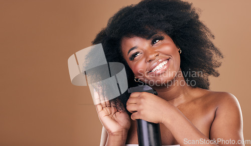 Image of Thinking, hair and spray with a model black woman in studio on a brown background for natural cosmetics. Face, smile and haircare with a happy afro female person indoor for dry shampoo treatment