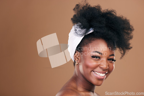 Image of Beauty, hair and face with a model black woman in studio on a brown background for natural cosmetics. Smile, skincare and haircare with a happy young afro female person indoor for shampoo treatment