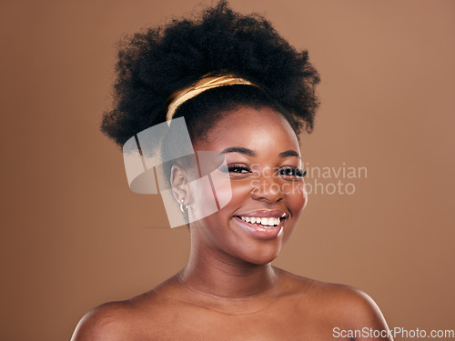 Image of Portrait, natural hair care or happy black woman with afro, self love or smile on a brown studio background. Hairstyle, healthy growth or African model with glow or beauty with aesthetic or wellness