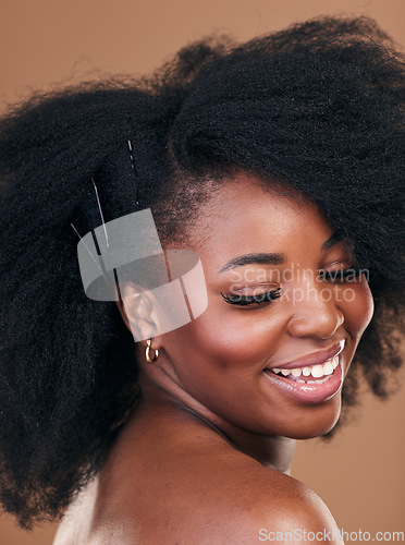 Image of Hair care, natural afro or happy black woman with self love, shine or smile on a brown studio background. Hairstyle, healthy growth or African model with glow or beauty with aesthetic or wellness