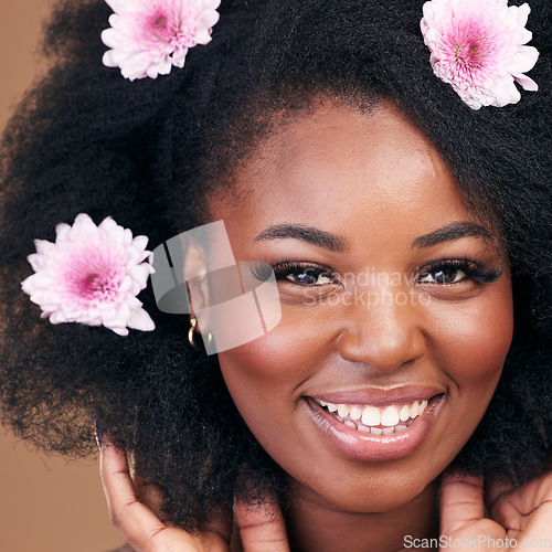 Image of Face, flowers and black woman in afro hair care, happy and beauty in studio isolated on a brown background. Portrait, floral hairstyle cosmetics and natural African model in organic salon treatment