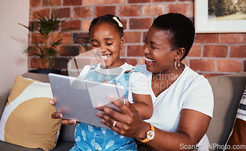 Image of Happy, African mom and girl on tablet in home, living room and lounge with online education, games and learning technology. Streaming, mobile app or mother and child relax with social media on sofa