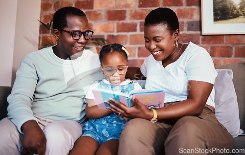 Image of Family, happy and reading a book on a home sofa with glasses for learning, knowledge and time together. A man, woman and girl kid in a lounge with love, care and happiness with a story in house