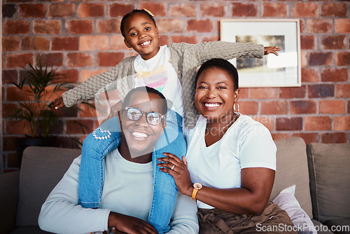 Image of Portrait of black family in home, parents and kid on sofa with piggy back, bonding and relax in lounge. Mom, dad and girl child on couch in apartment with playful man, woman and daughter together.
